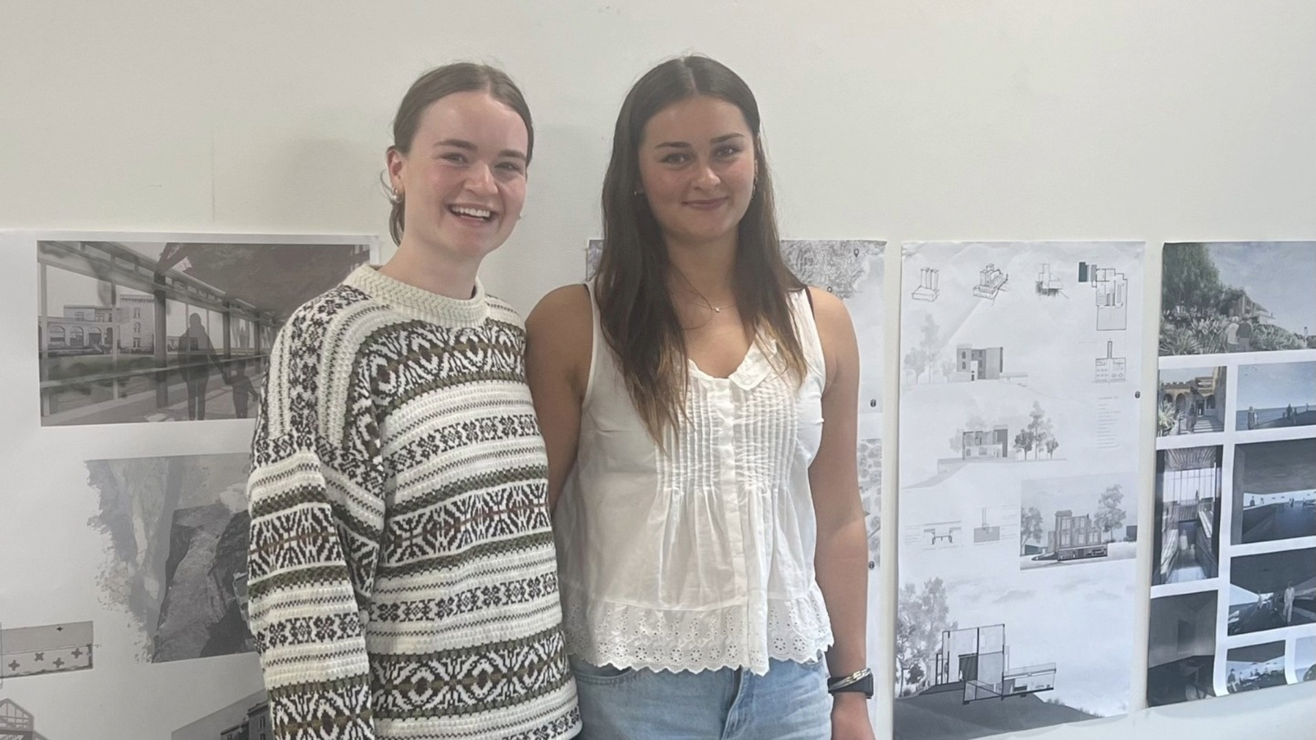 Two architecture students stand in front of detailed proposals for Cargill's Castle